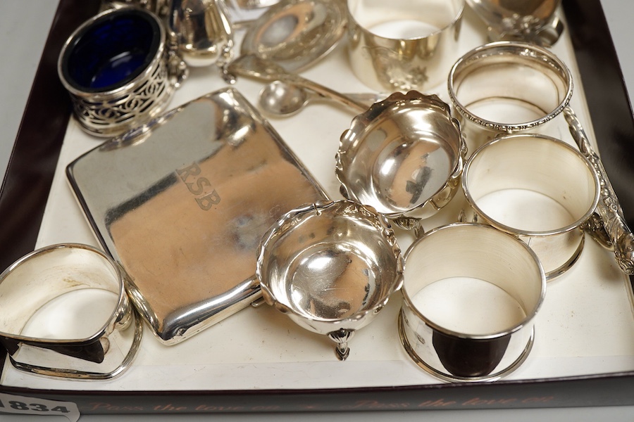 A collection of silver to inlcude a George V cigarette case, Victorian and later cruet items, assorted napkin rings etc. various, weighable silver approx. 18.4ozt